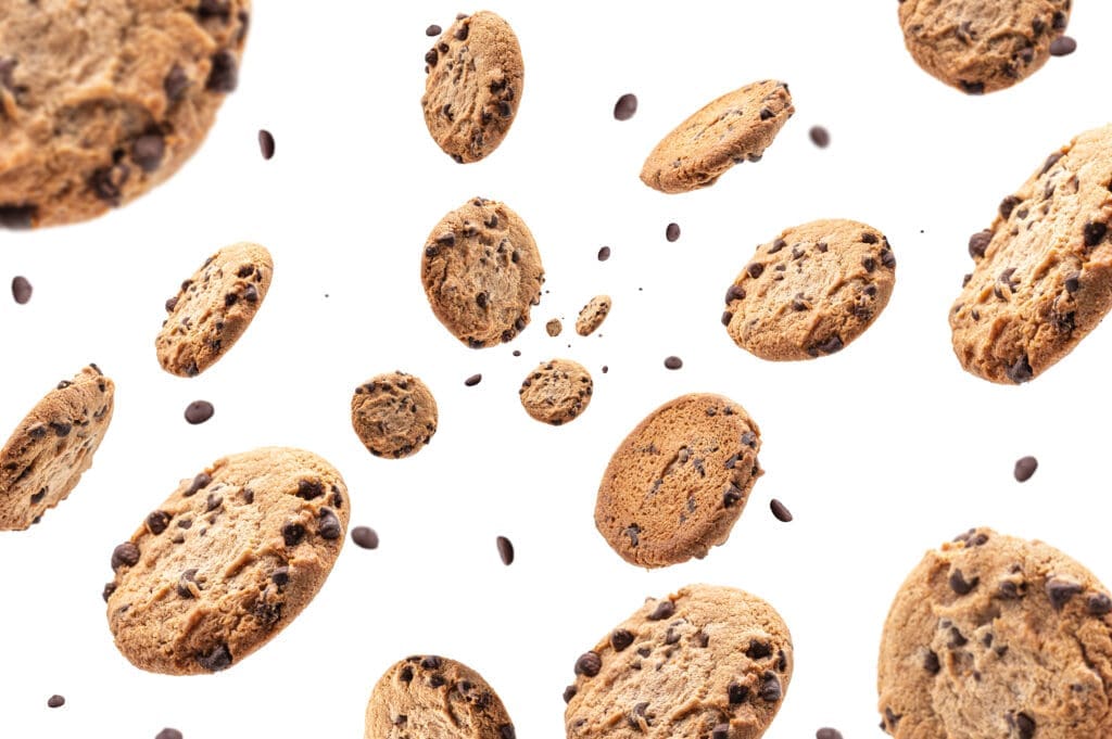 Collection of half chocolate chip cookies on white background