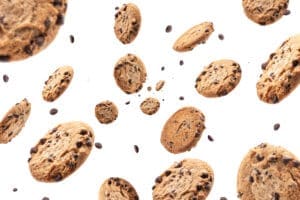 Collection of half chocolate chip cookies on white background