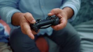 Man hands playing game with joystick.